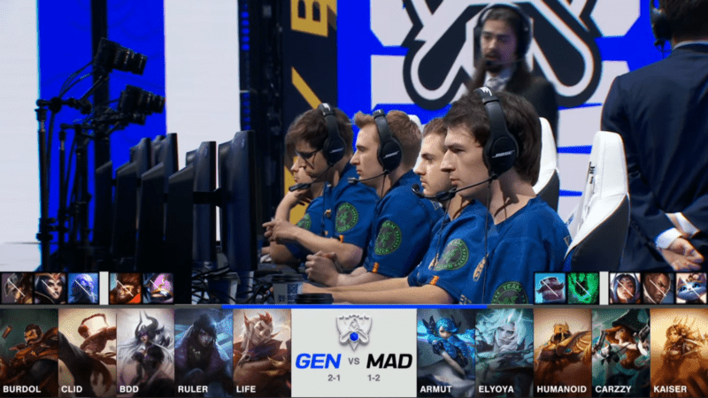 A screenshot from the 2021 World Championship Main Event Group Stage broadcast, showing the champion drafts between Gen.G and MAD Lions with a shot of the MAD Lions team and coaches on stage above.
